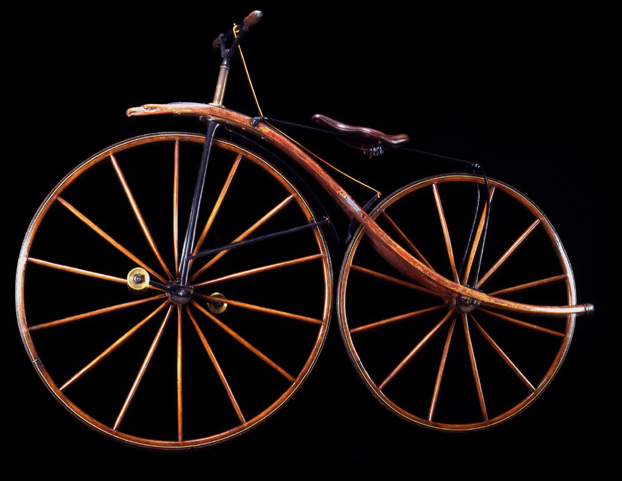 Velocipede, ca. 1870<br>
George C. Miller, Chicago<br>
United States<p>
	
The ornate front extension with the
carved eagle's head and the wood frame
that sweeps beyond the rear wheel are
unique embellishments.